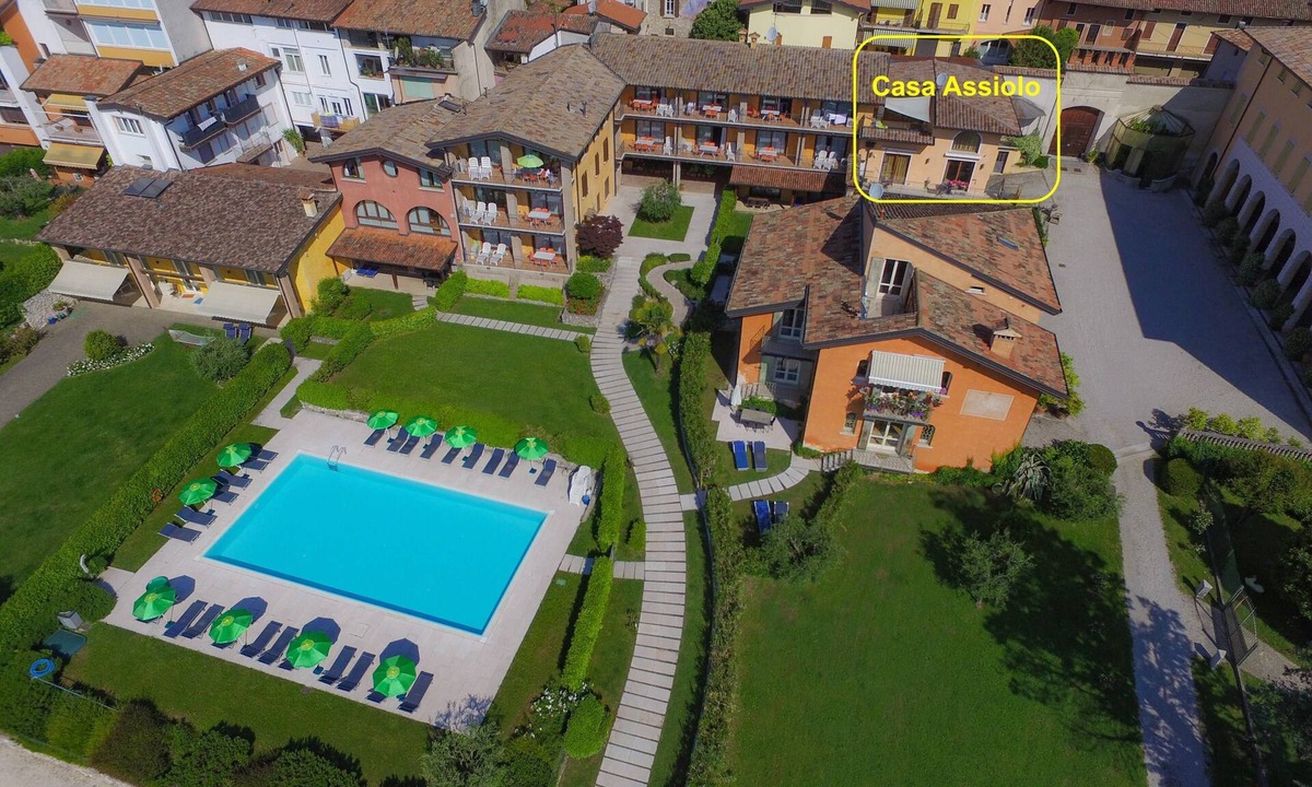 Moniga del Garda Apartment | Casa Assiolo with balcony, garden and lake view. Inside Residence Corte Ferrari