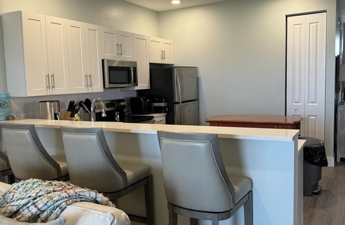 Treasure Cay Condo | A beautiful white sand beach, an inviting pool and lush grounds.