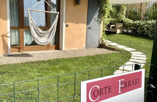 Moniga del Garda Apartment | Casa Assiolo with balcony, garden and lake view. Inside Residence Corte Ferrari