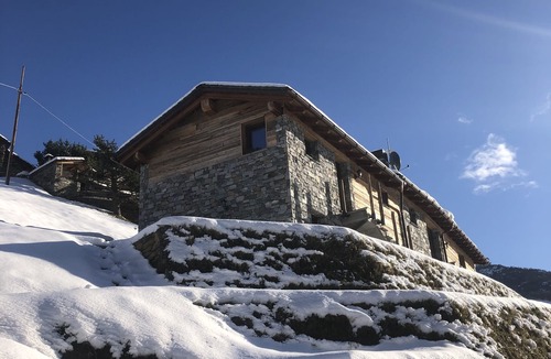 Valtellina Cabin | Characteristic lodge surrounded by nature near the ski facilities.