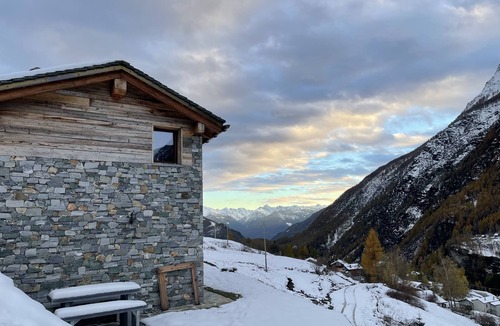 Valtellina Cabin | Characteristic lodge surrounded by nature near the ski facilities.