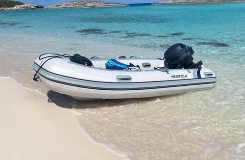 George Town Boat Rental | Water Glamping over turquoise blue water.