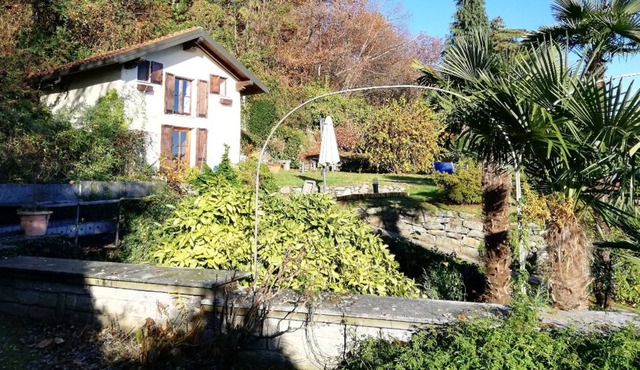 Romantic cottage surrounded by greenery with lake view