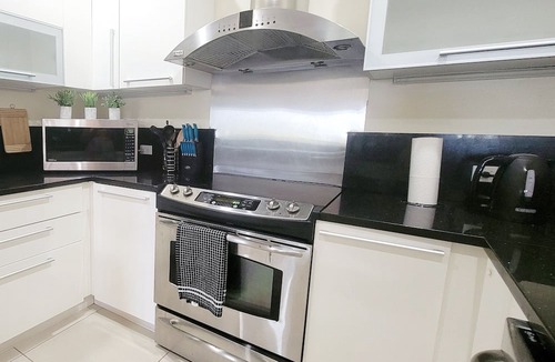 Bahamia West Condo | Gated Lux family size condo near beach w/boat dock, working station, pool, canal